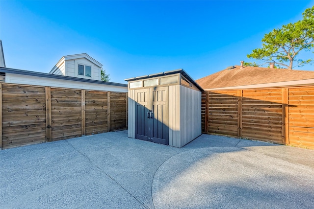 view of shed with fence