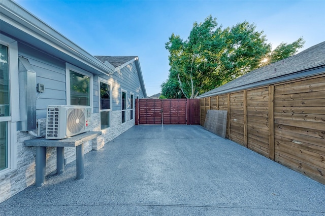 view of patio / terrace with ac unit and fence