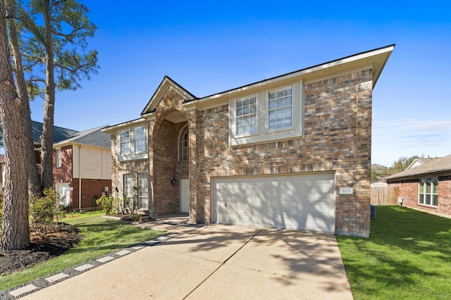 view of front of property featuring a garage, a front yard, brick siding, and driveway