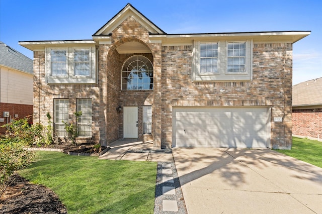 view of front of property with a garage, driveway, brick siding, and a front yard