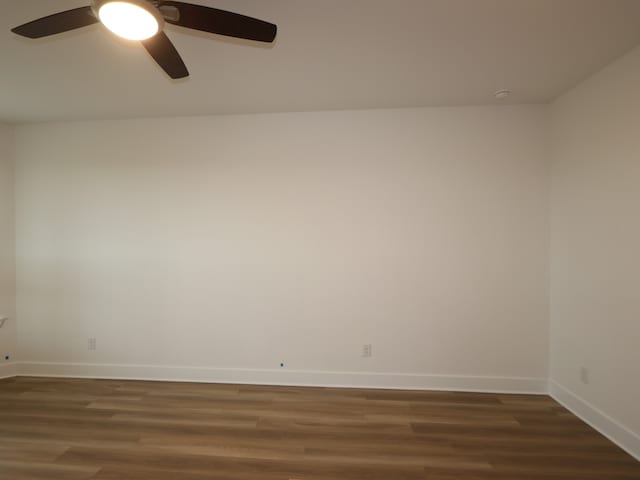 21706 Persian Lake Dr, Cypress, TX 77433 - unfurnished room featuring a ceiling fan and dark wood finished floors