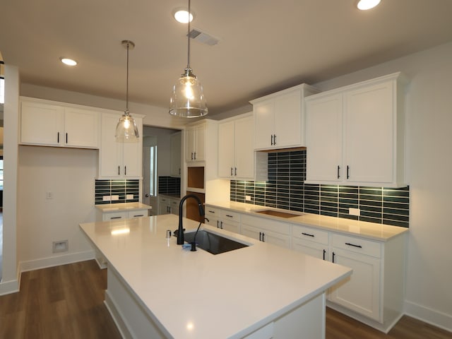 21706 Persian Lake Dr, Cypress, TX 77433 - kitchen featuring a center island with sink, dark wood-type flooring, recessed lighting, backsplash, and white cabinets