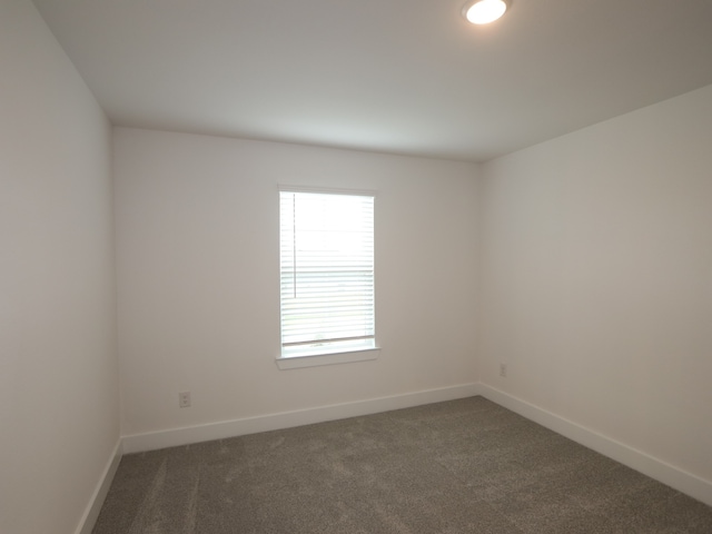 21706 Persian Lake Dr, Cypress, TX 77433 - spare room featuring dark colored carpet and baseboards