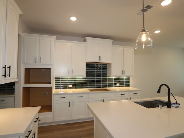 21706 Persian Lake Dr, Cypress, TX 77433 - kitchen featuring black electric stovetop, white cabinets, wood finished floors, backsplash, and recessed lighting