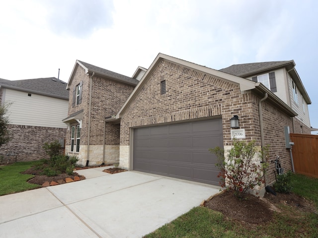 21706 Persian Lake Dr, Cypress, TX 77433 - view of front of home with brick siding, an attached garage, and concrete driveway