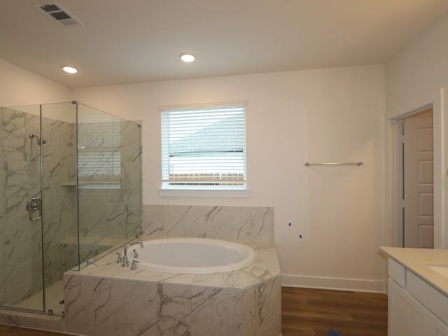 21706 Persian Lake Dr, Cypress, TX 77433 - bathroom with a bath, a marble finish shower, vanity, wood finished floors, and recessed lighting