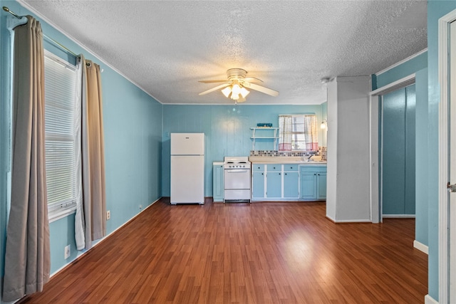 kitchen with ceiling fan, white appliances, dark wood-style flooring, light countertops, and ornamental molding