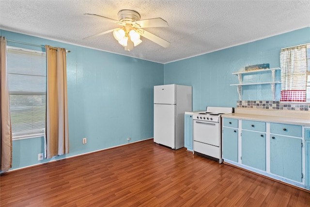 kitchen featuring open shelves, light countertops, a ceiling fan, wood finished floors, and white appliances