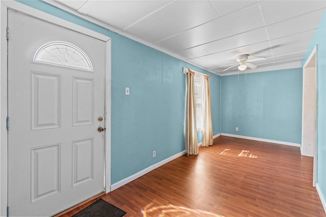 entrance foyer with ceiling fan, wood finished floors, and baseboards