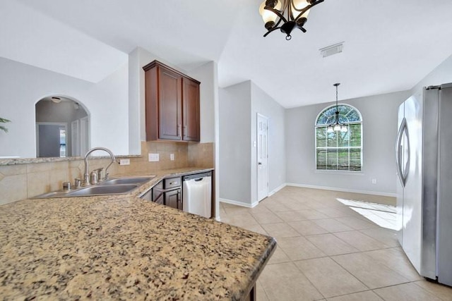 21722 Sierra Long Dr, Richmond, TX 77407 - kitchen featuring appliances with stainless steel finishes, a sink, visible vents, and an inviting chandelier