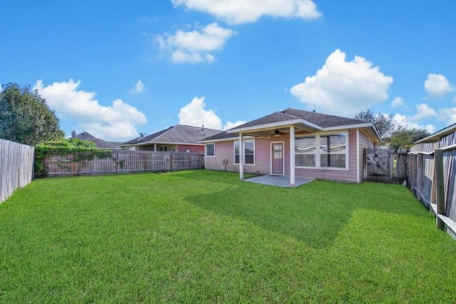 21722 Sierra Long Dr, Richmond, TX 77407 - back of house featuring a ceiling fan, a patio area, a fenced backyard, and a lawn