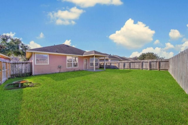 21722 Sierra Long Dr, Richmond, TX 77407 - back of property featuring a lawn and a fenced backyard