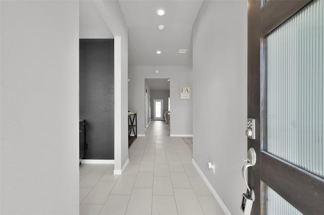 foyer with light tile patterned flooring, baseboards, and recessed lighting