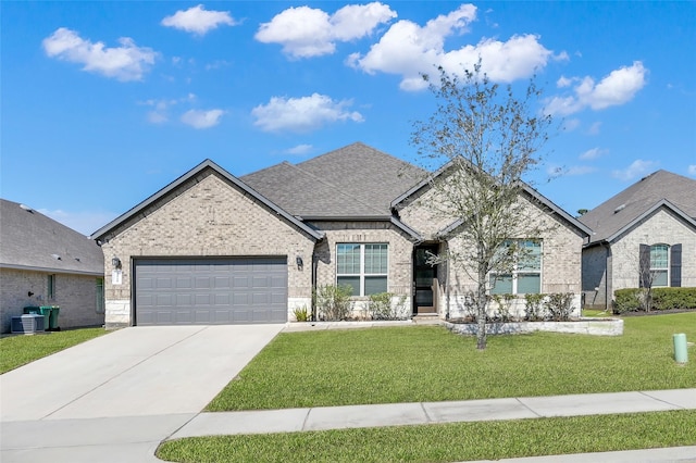 french country style house with concrete driveway, brick siding, roof with shingles, and a front yard