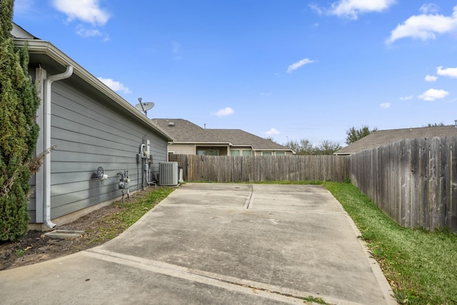 exterior space with cooling unit, a patio area, and a fenced backyard