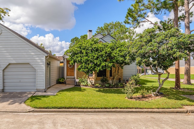 view of front of home featuring entry steps, concrete driveway, and a front yard