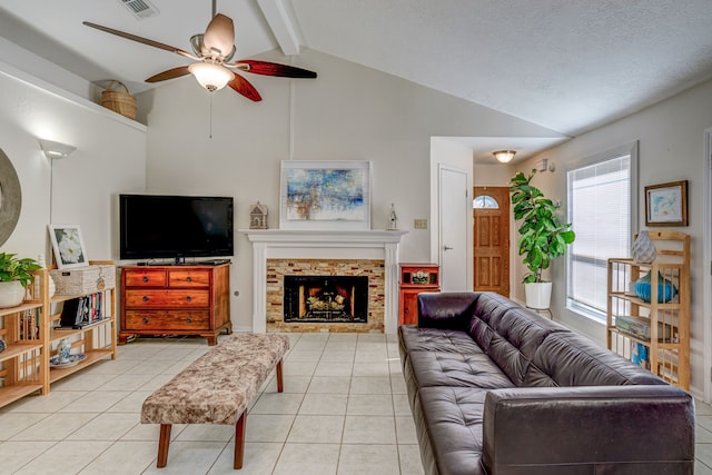 living room with visible vents, a fireplace, lofted ceiling with beams, and light tile patterned floors