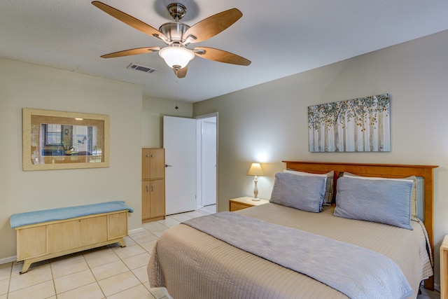 bedroom featuring light tile patterned floors, ceiling fan, visible vents, and baseboards