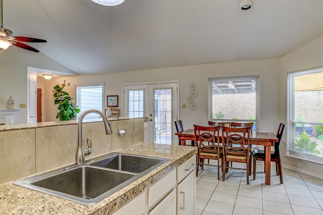 kitchen featuring a wealth of natural light, light countertops, a sink, and lofted ceiling