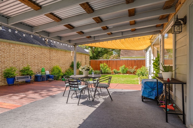 view of patio featuring outdoor dining space and fence