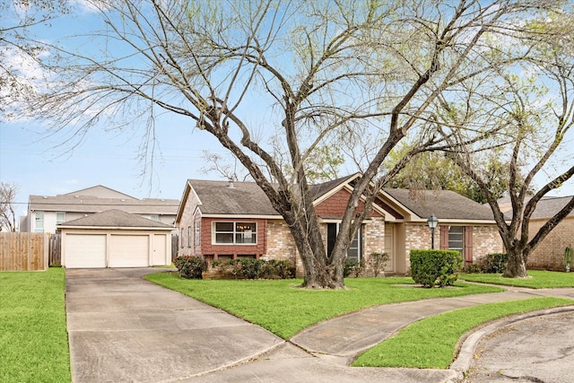 ranch-style home with brick siding, an outdoor structure, a front yard, and fence