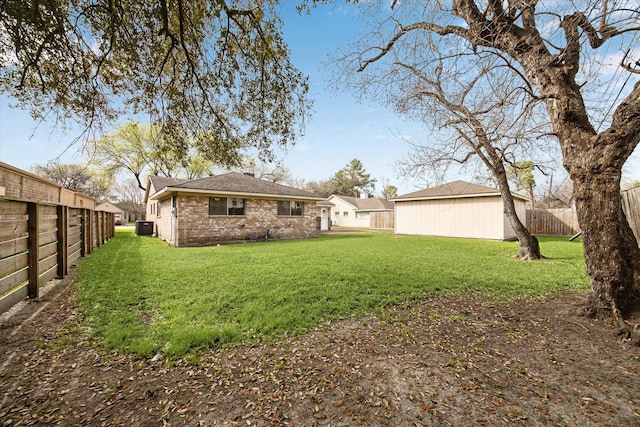 view of yard with central AC and a fenced backyard