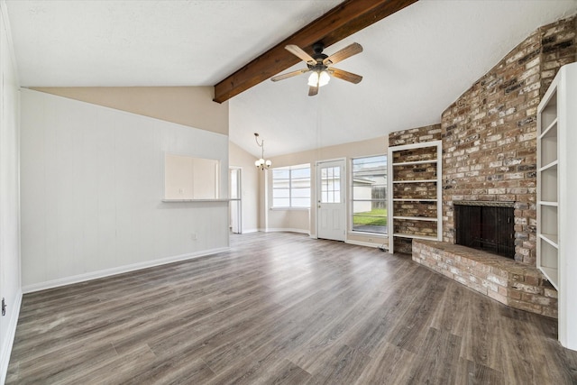 unfurnished living room featuring ceiling fan with notable chandelier, wood finished floors, vaulted ceiling with beams, and a fireplace