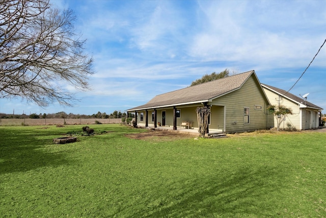 exterior space featuring a lawn and a fire pit