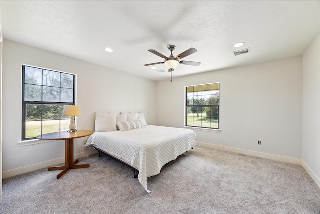 bedroom featuring carpet floors, recessed lighting, visible vents, and baseboards