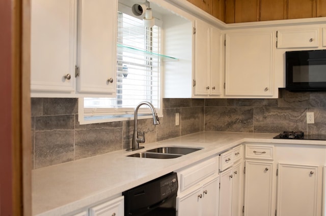 kitchen featuring black appliances, a sink, light countertops, and white cabinetry