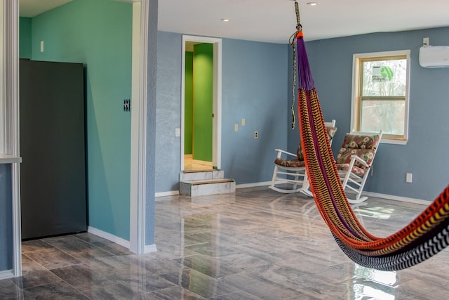 game room with marble finish floor, baseboards, and a wall mounted AC