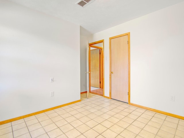 spare room with visible vents and baseboards