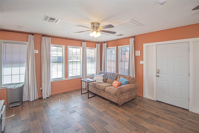 interior space featuring wood finish floors, visible vents, and a ceiling fan