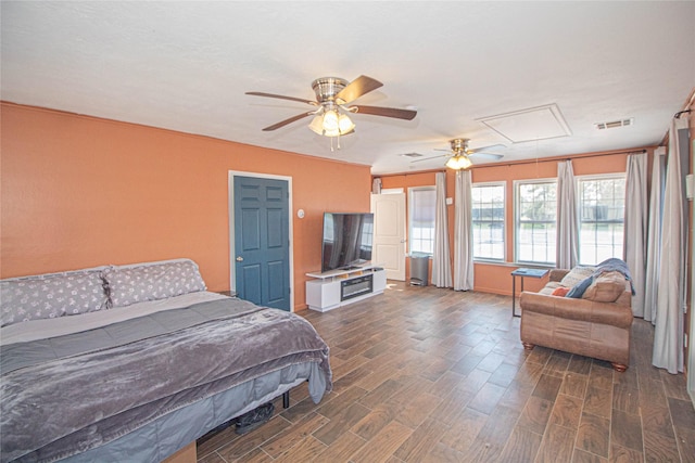 bedroom featuring attic access, dark wood-style flooring, and visible vents