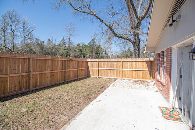 view of yard featuring a patio area and a fenced backyard