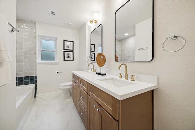 bathroom with marble finish floor, double vanity, visible vents, a sink, and baseboards