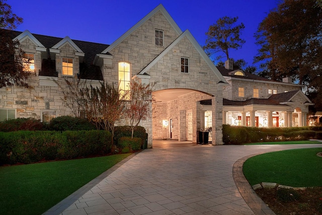 french country inspired facade featuring decorative driveway