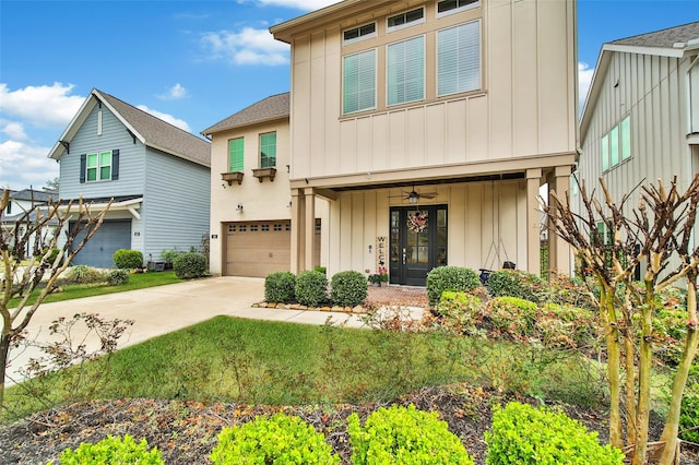 view of front of property with board and batten siding, concrete driveway, and a garage