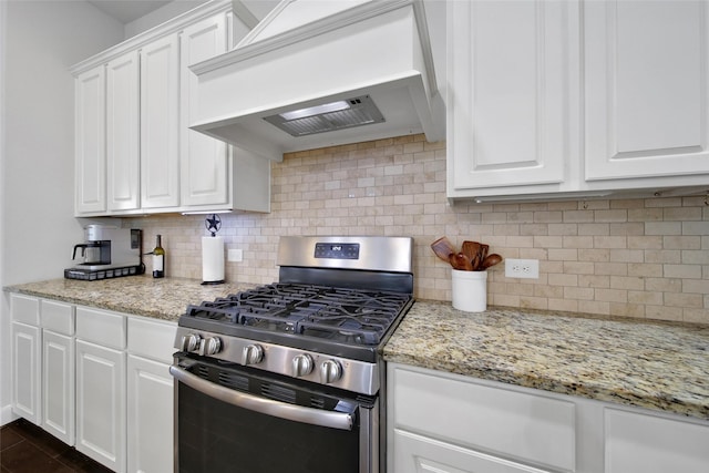 kitchen featuring gas stove, white cabinetry, tasteful backsplash, and custom range hood