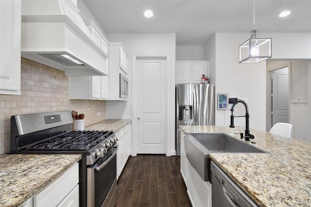 kitchen featuring dark wood-style floors, custom exhaust hood, a sink, appliances with stainless steel finishes, and backsplash