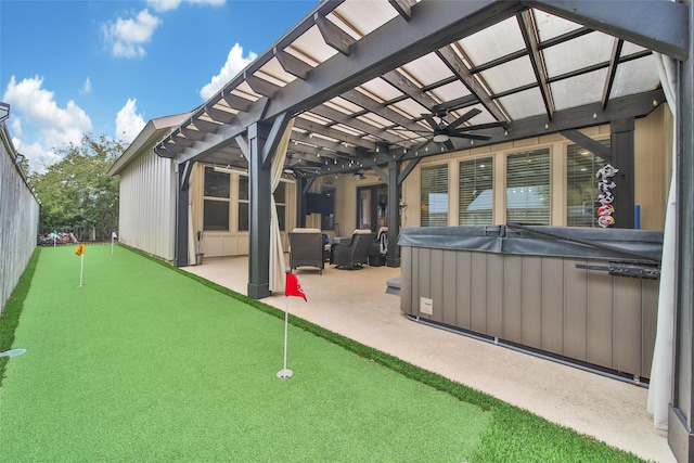 view of patio / terrace featuring a ceiling fan and a hot tub