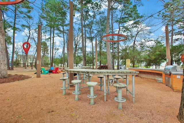 exterior space with grilling area and an outdoor kitchen