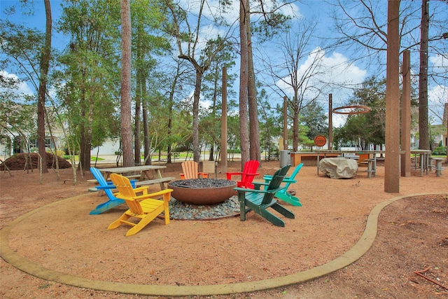 view of playground featuring an outdoor fire pit