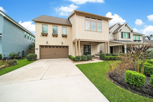 view of front facade featuring a garage, board and batten siding, concrete driveway, and a front lawn