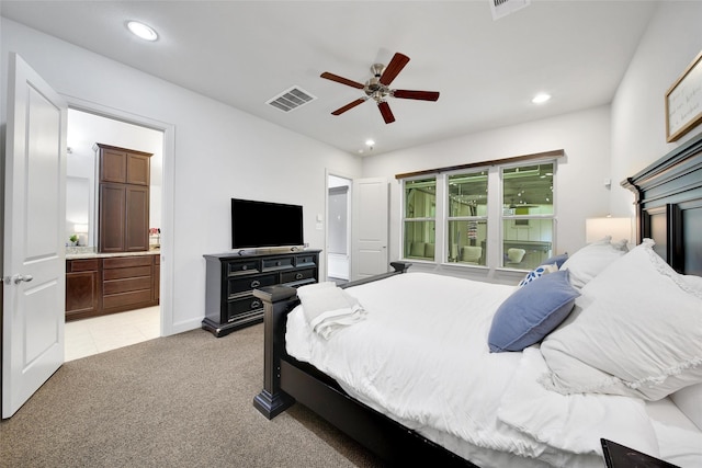 bedroom with visible vents, ensuite bath, recessed lighting, light colored carpet, and ceiling fan