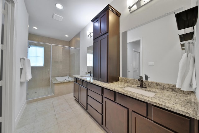 bathroom with a sink, a stall shower, double vanity, and a bath