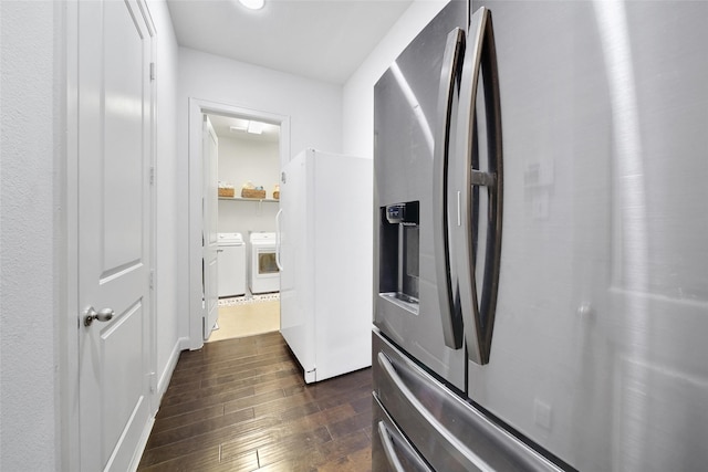 kitchen featuring stainless steel fridge, independent washer and dryer, dark wood finished floors, and freestanding refrigerator