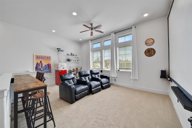 living area with a ceiling fan, recessed lighting, light colored carpet, and baseboards