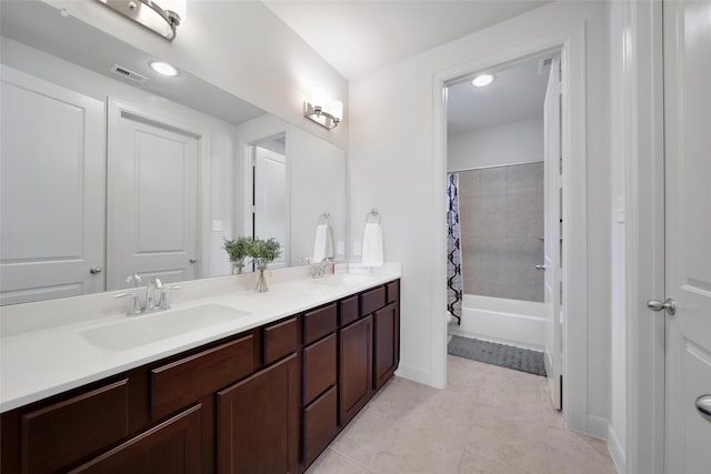 bathroom with double vanity, visible vents, shower / tub combo, and a sink