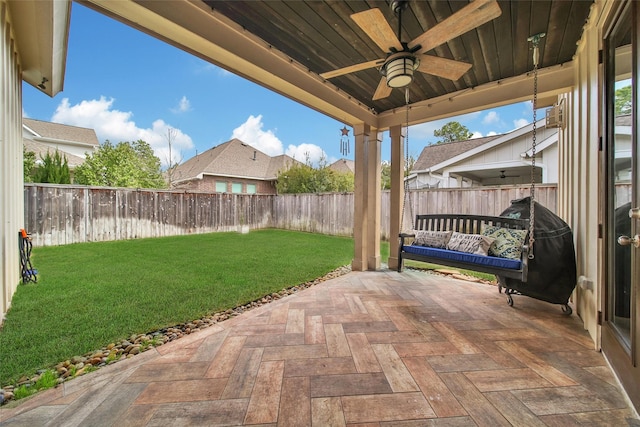 view of patio with a fenced backyard and ceiling fan